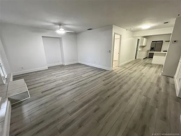 a view of a kitchen with wooden floor and electronic appliances