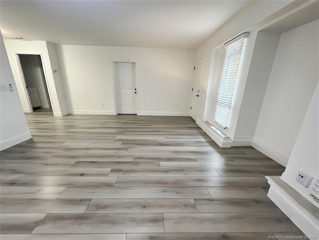 808 Southwest 33rd Street Palm City, FL 34990 - Photo 3 of 13 a view of empty room with wooden floor