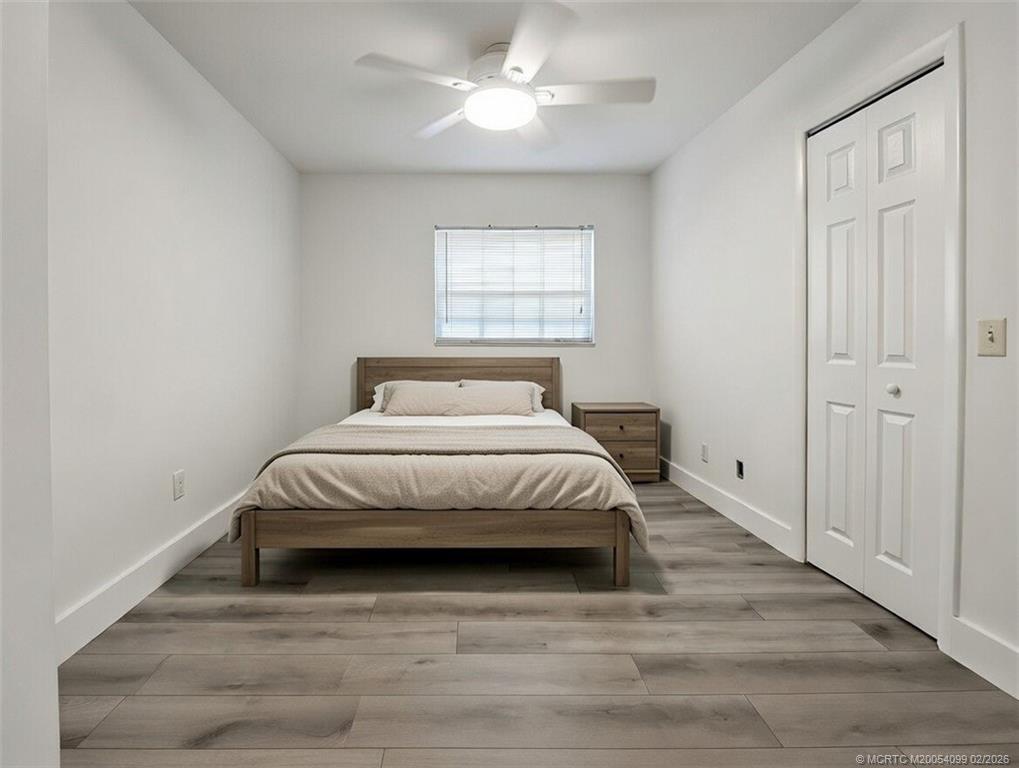 808 Southwest 33rd Street Palm City, FL 34990 - Photo 4 of 13 a bedroom with a bed and a window
