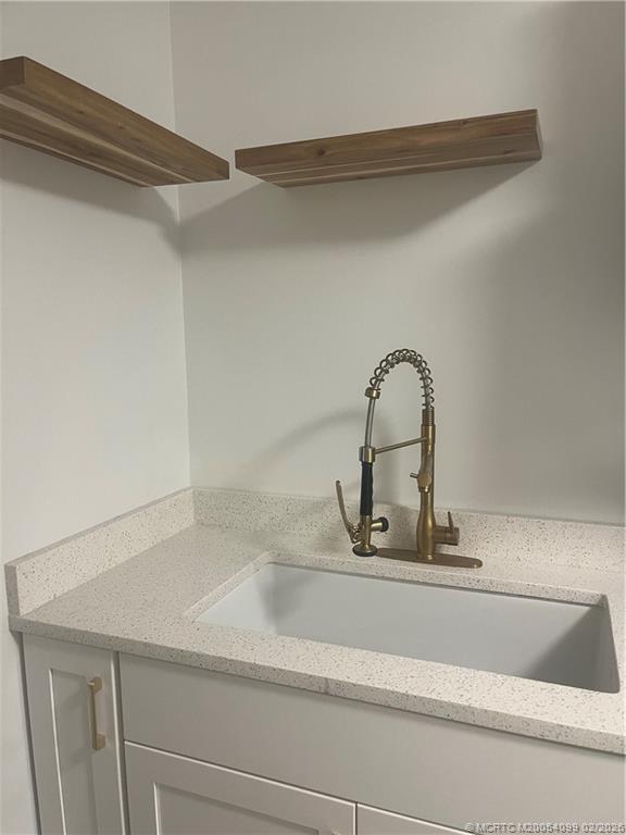 808 Southwest 33rd Street Palm City, FL 34990 - Photo 8 of 13 a bathroom with a sink and a mirror