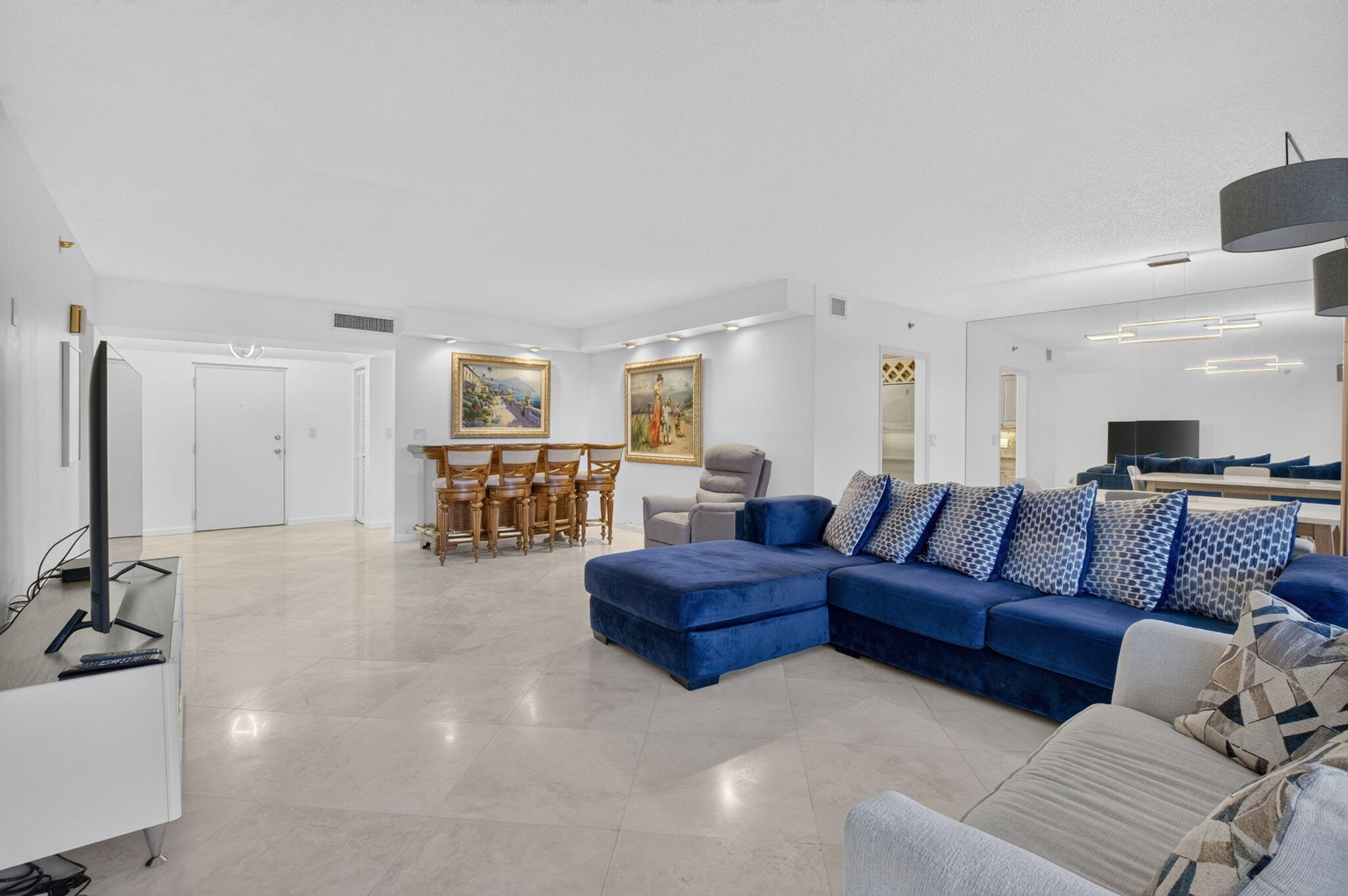 1401 South Ocean Boulevard, Unit 1060 Boca Raton, FL 33432 - Photo 5 of 46 a living room with a couch and a view of kitchen