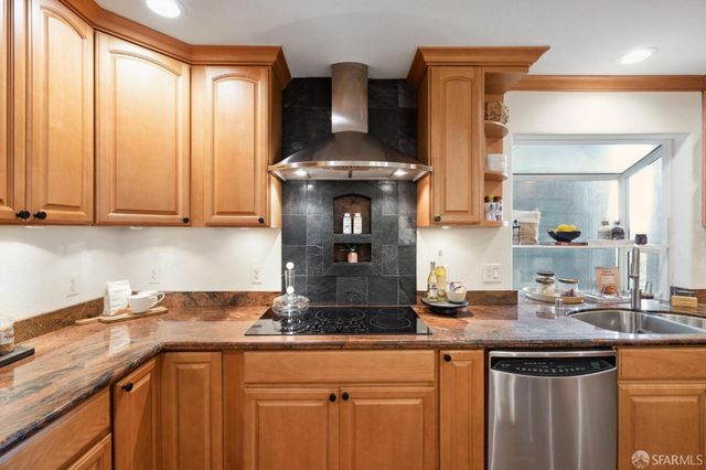a kitchen with stainless steel appliances granite countertop a sink and cabinets