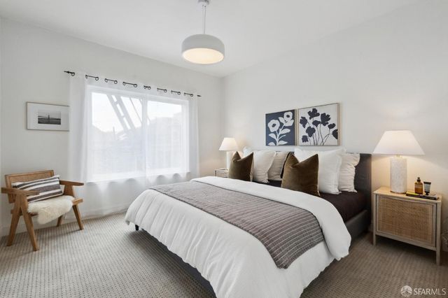 a bedroom with a bed and a lamp