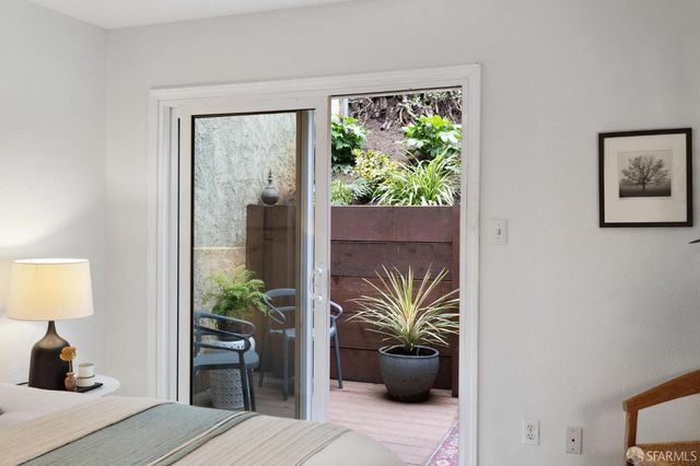 a view of living room filled with furniture and a potted plant
