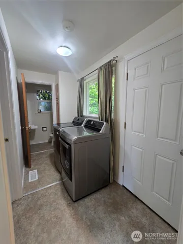 a utility room with faucet a washer and dryer