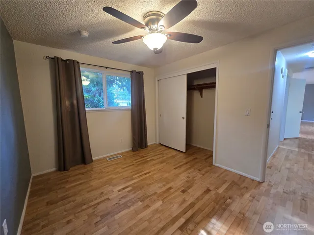 a view of a livingroom with a ceiling fan and window