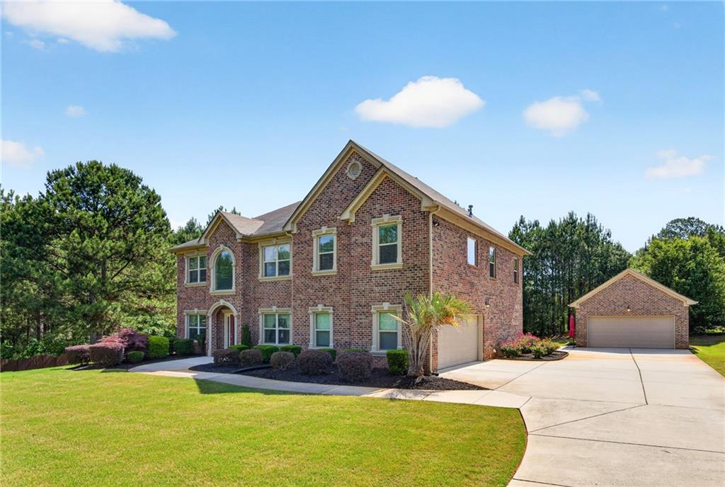 2300 Tucker Mill Road Southwest Conyers, GA 30094 - Photo 1 of 45 a front view of a house with a yard and garage