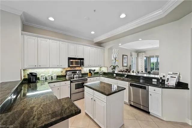 a kitchen with a sink a stove top oven and cabinets