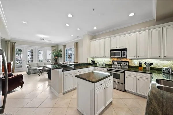 a kitchen with counter top space appliances and cabinets