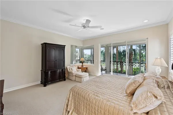 a bedroom with a large bed and a large window