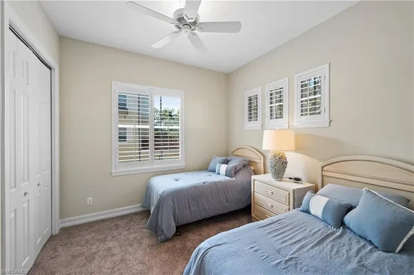 a bedroom with two beds and a window