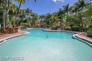 a view of a swimming pool with a table and chairs