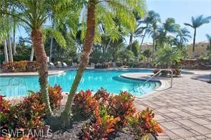 a view of a lake with a bench and trees around