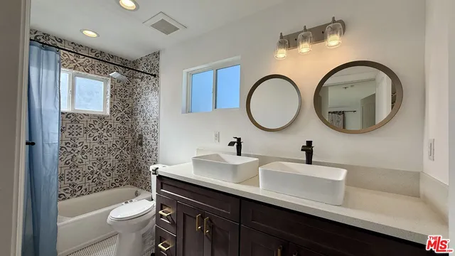 a bathroom with a toilet a sink and a mirror