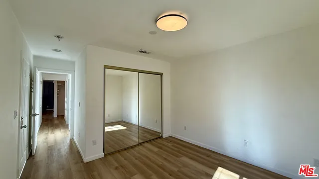 a view of a room with wooden floor