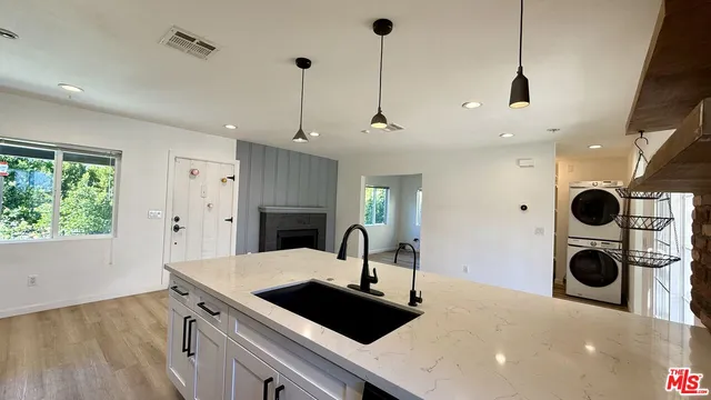a kitchen with a sink and a stove top oven