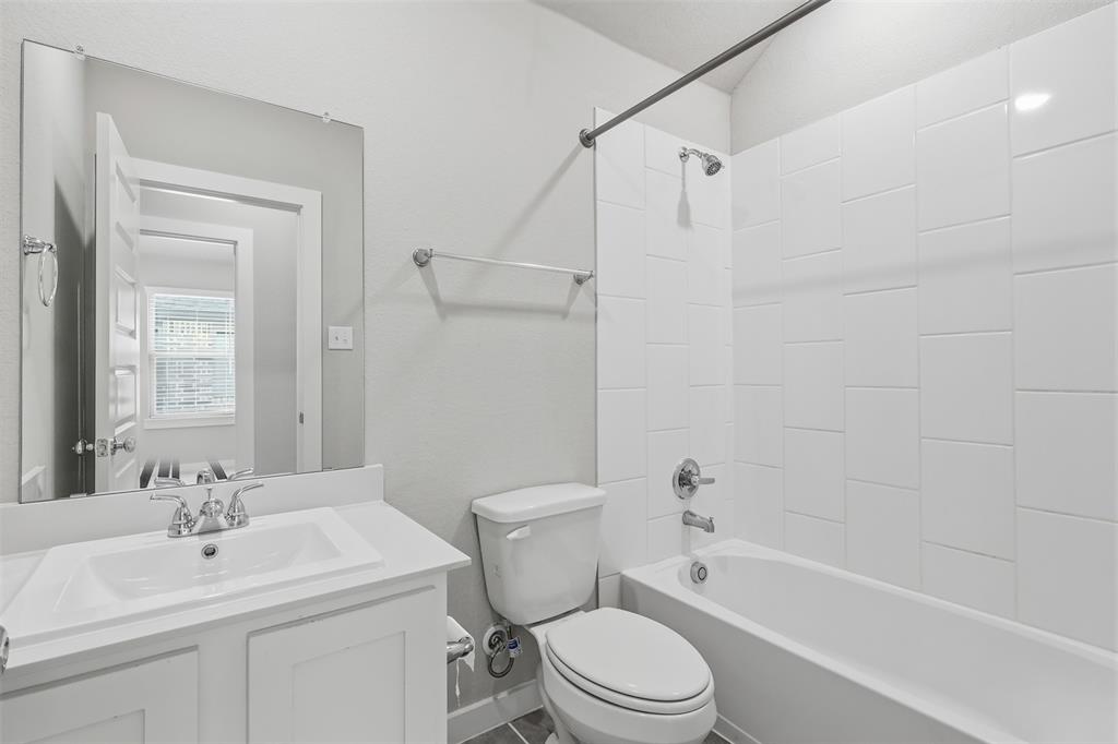 2629 Green River Road Royse City, TX 75189 - Photo 10 of 18 a bathroom with a toilet a sink a mirror a bathtub and vanity