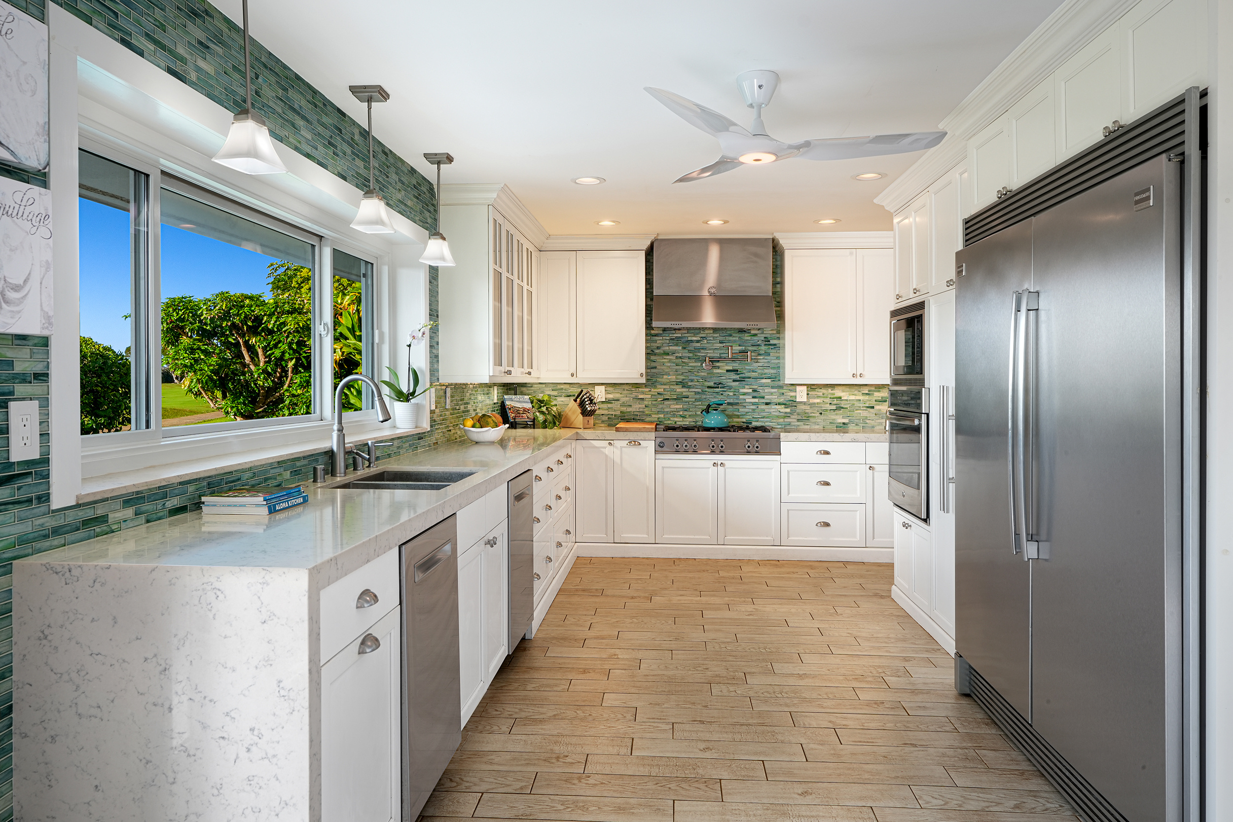 5348 Honoiki Road Princeville, HI 96722 - Photo 11 of 25 a large kitchen with stainless steel appliances granite countertop a refrigerator and a sink
