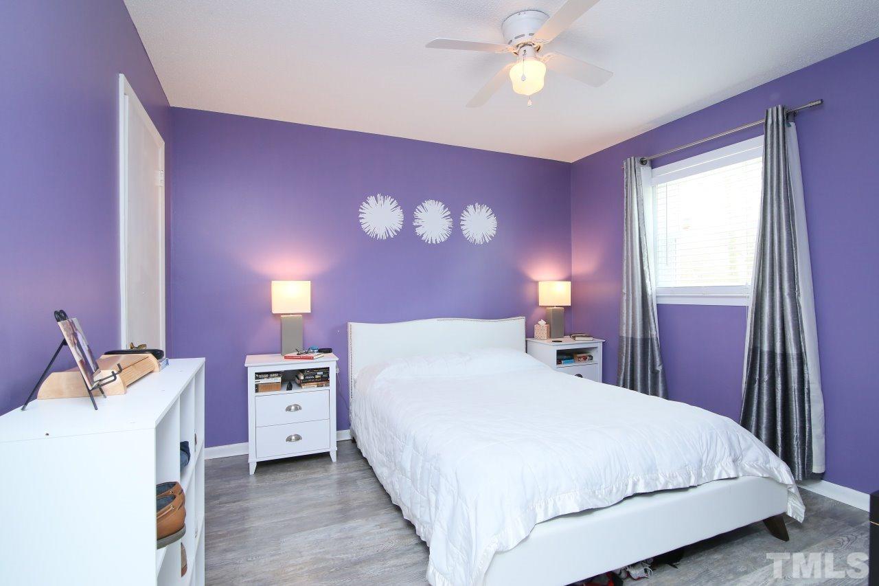 1501 Westchester Road Raleigh, NC 27610 - Photo 11 of 25 a bedroom with a bed and a chandelier