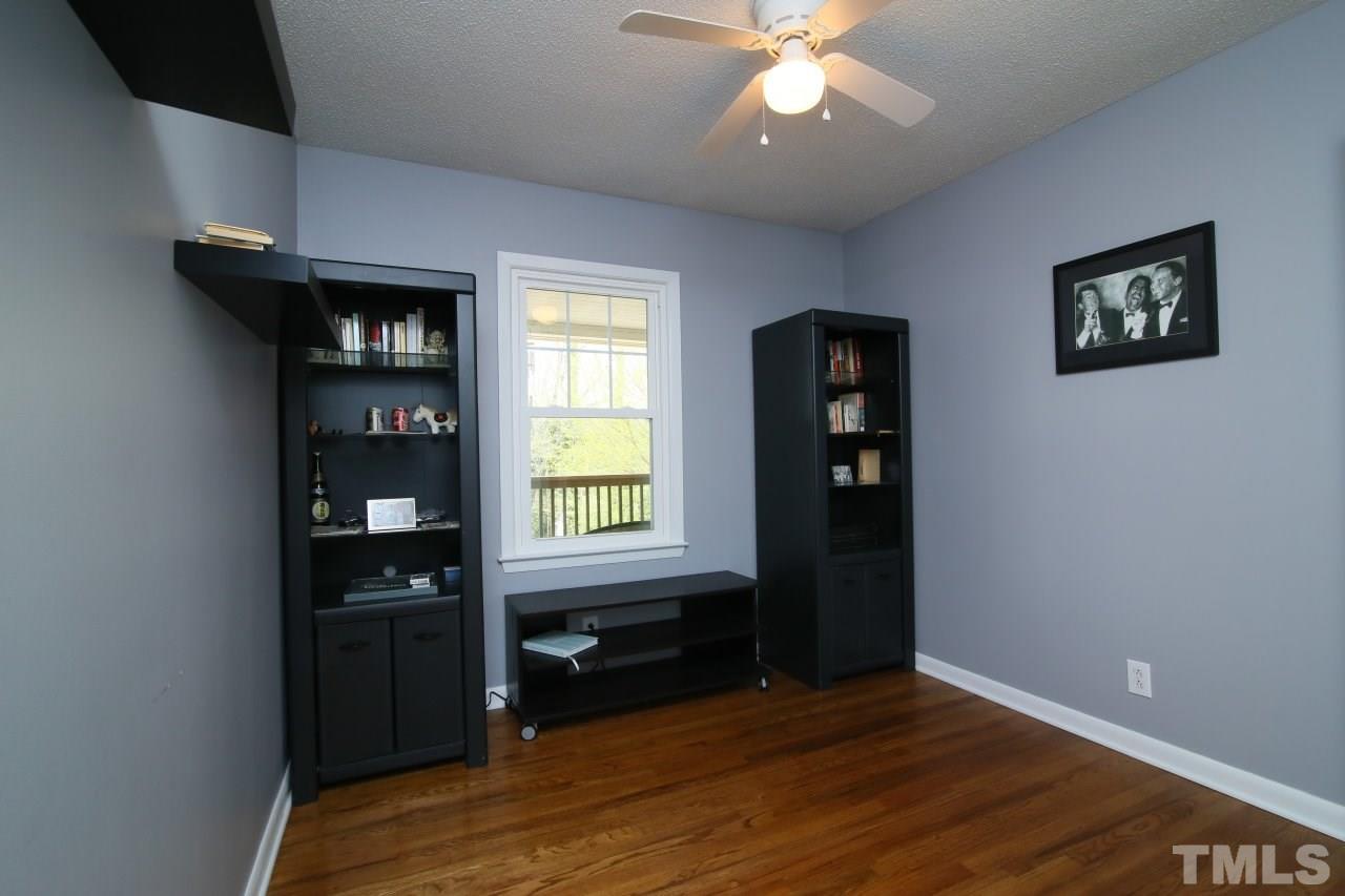 1501 Westchester Road Raleigh, NC 27610 - Photo 14 of 25 a view of an empty room with a window and wooden floor