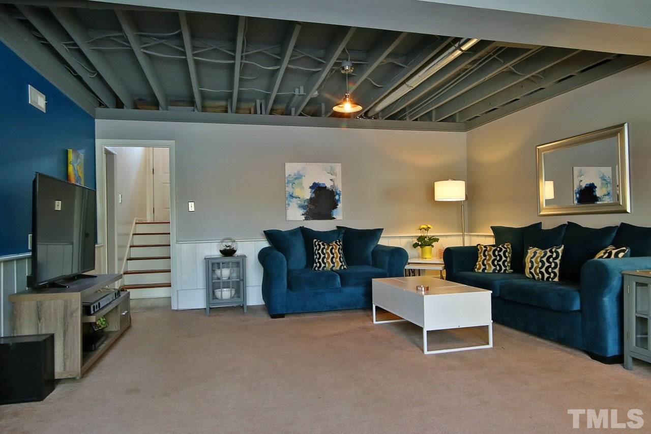 1501 Westchester Road Raleigh, NC 27610 - Photo 17 of 25 a living room with furniture and a flat screen tv