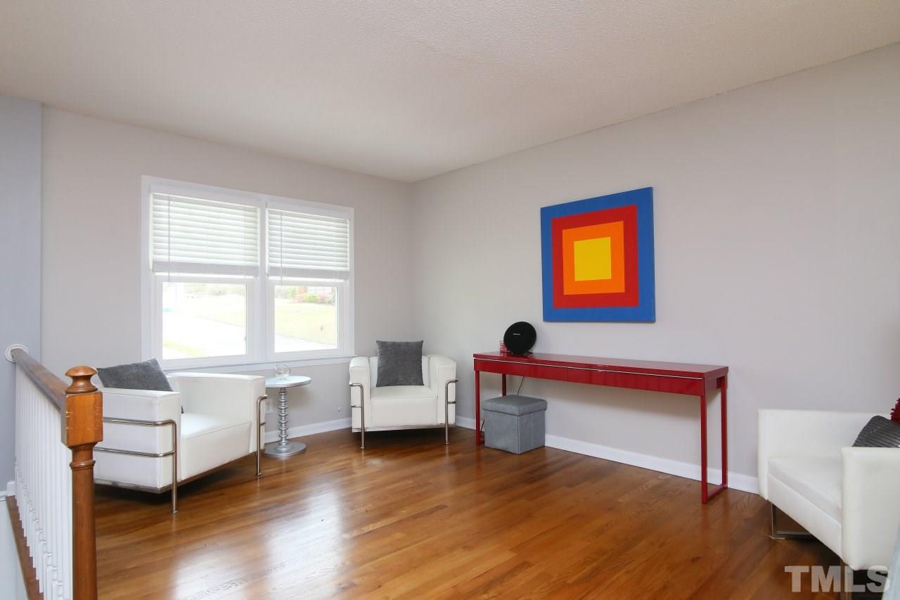 1501 Westchester Road Raleigh, NC 27610 - Photo 3 of 25 a living room with furniture and a wooden floor