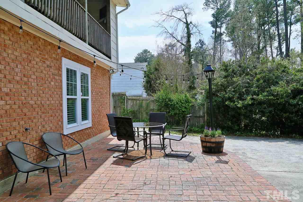 1501 Westchester Road Raleigh, NC 27610 - Photo 21 of 25 a view of a patio with table and chairs and potted plants
