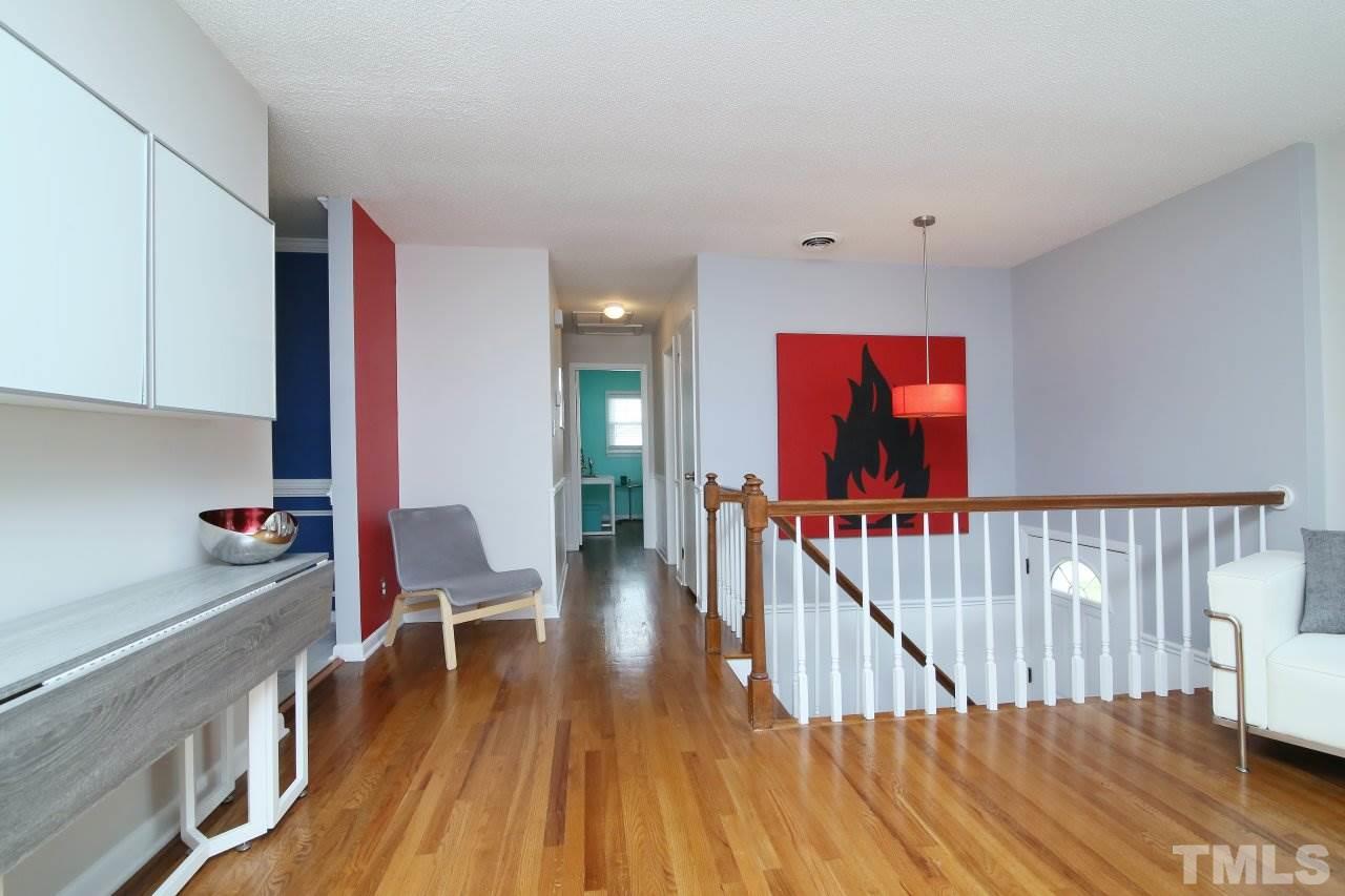 1501 Westchester Road Raleigh, NC 27610 - Photo 4 of 25 a view of hallway with wooden floor and stairs