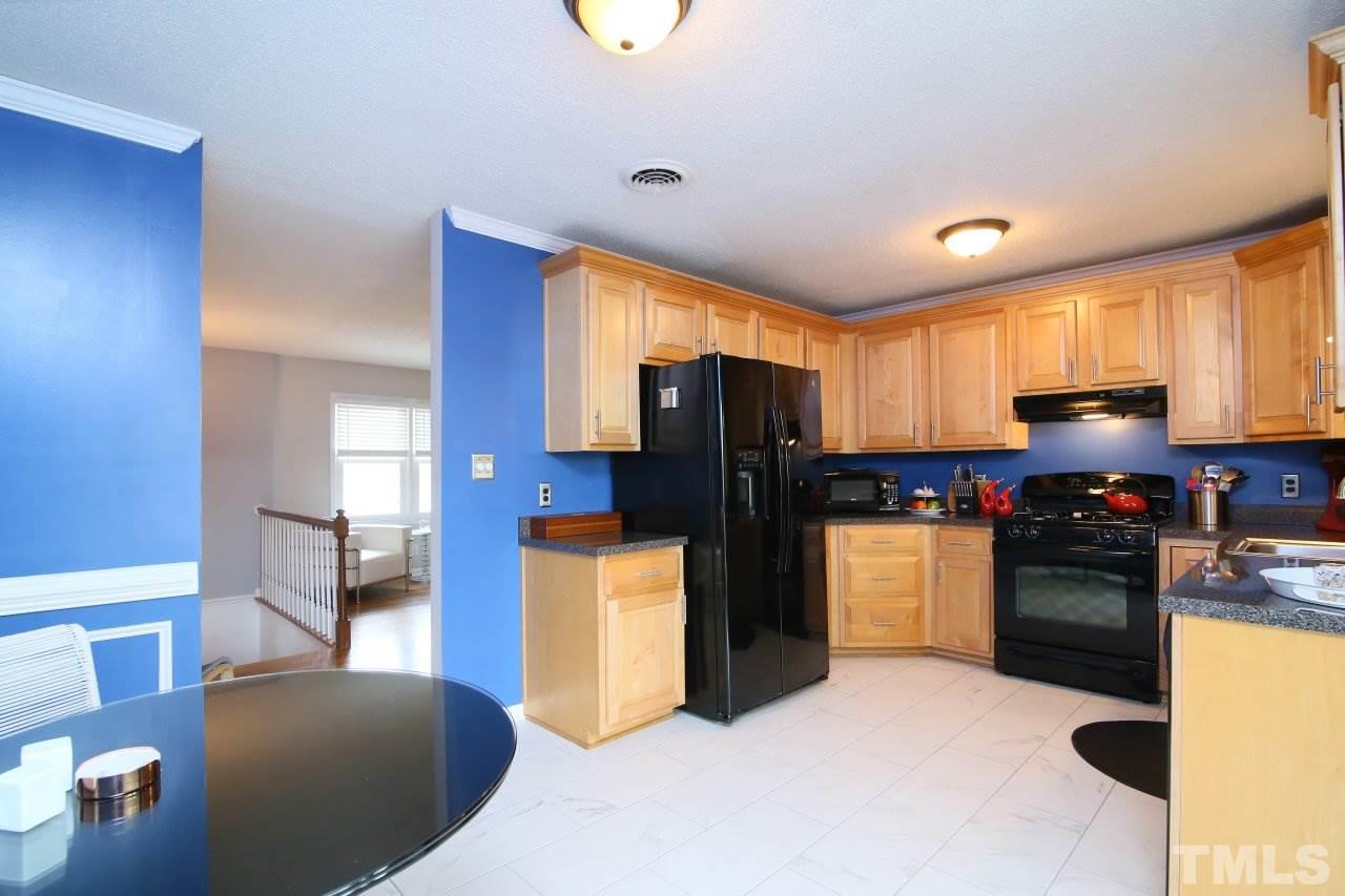 1501 Westchester Road Raleigh, NC 27610 - Photo 7 of 25 a kitchen with refrigerator and microwave