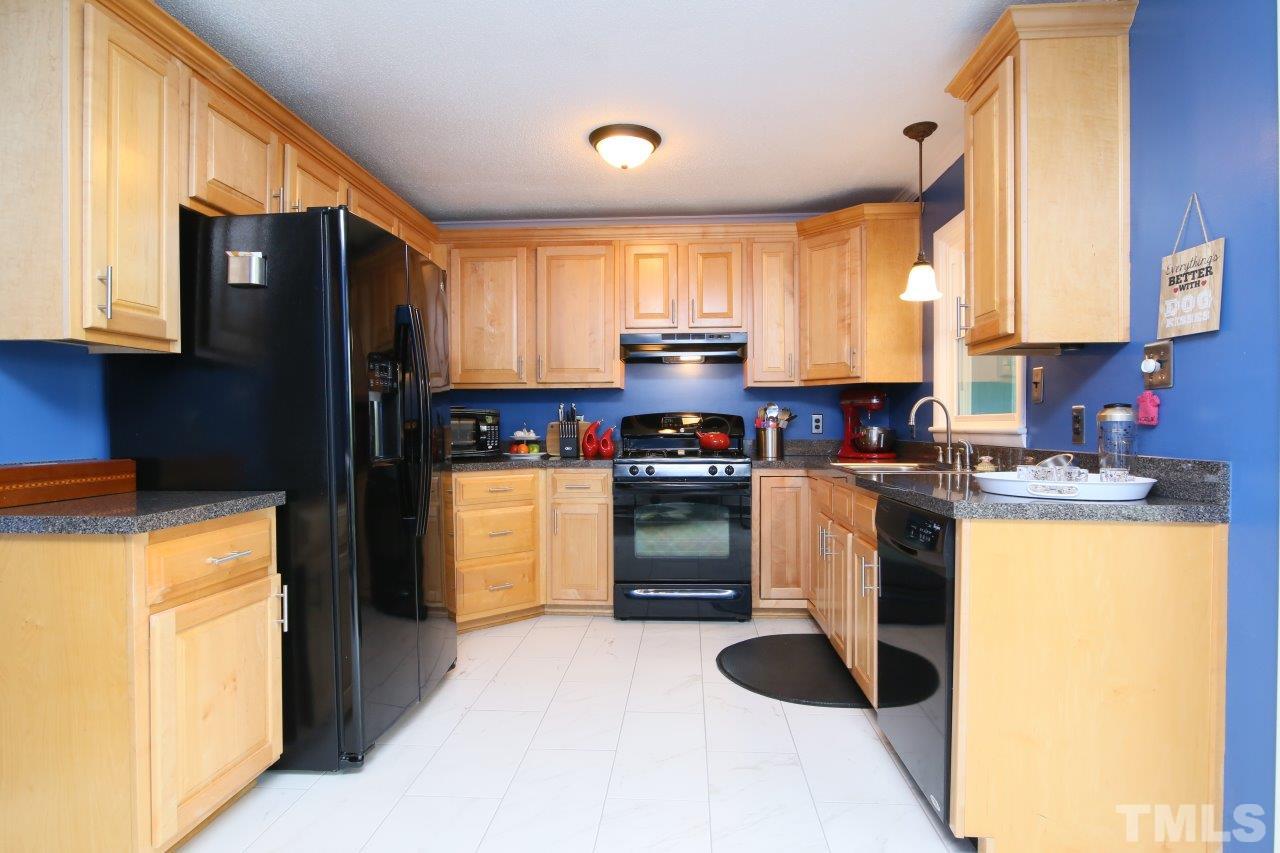 1501 Westchester Road Raleigh, NC 27610 - Photo 8 of 25 a kitchen with refrigerator and cabinets