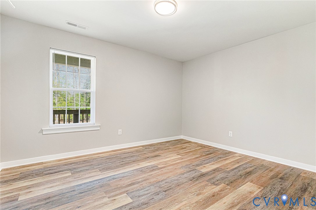5301 Pine Fork Road Quinton, VA 23141 - Photo 28 of 41 a view of empty room with wooden floor and fan