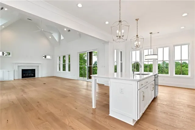 a kitchen with stainless steel appliances kitchen island granite countertop a kitchen island and chairs in it