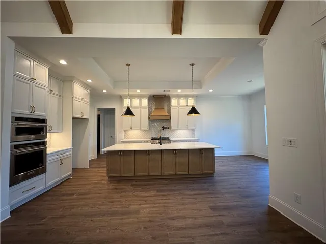 a white bath tub sitting next to a white cabinet