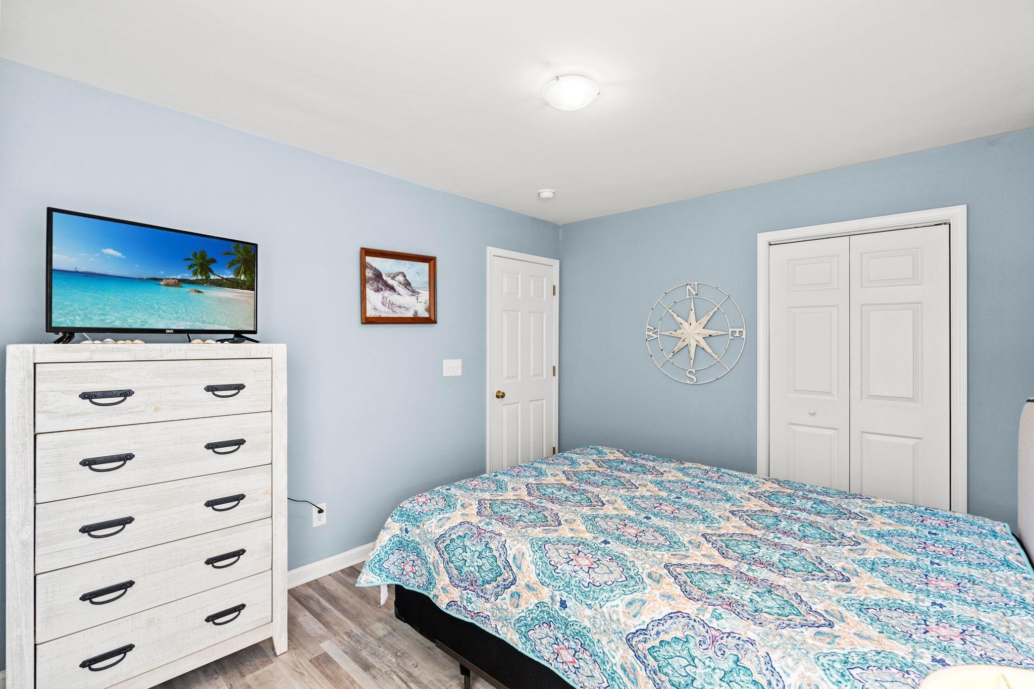 232 Marbella Drive Murrells Inlet, SC 29576 - Photo 18 of 40 Bedroom with light wood finished floors and a clos