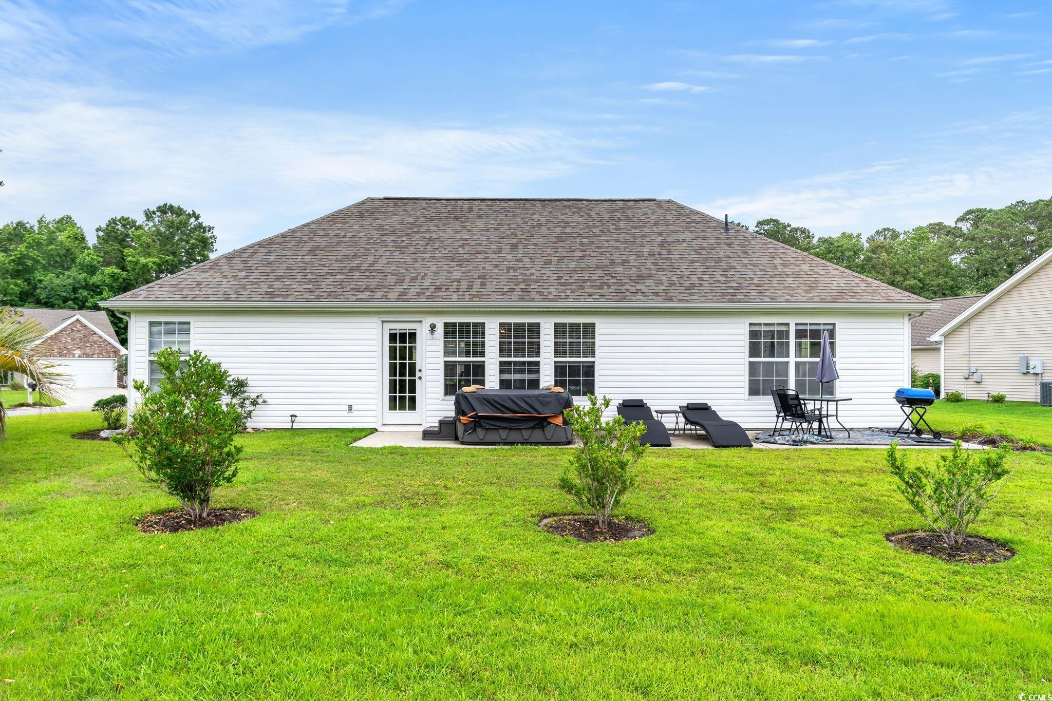 232 Marbella Drive Murrells Inlet, SC 29576 - Photo 23 of 40 Back of house featuring a patio, a yard, and a shi