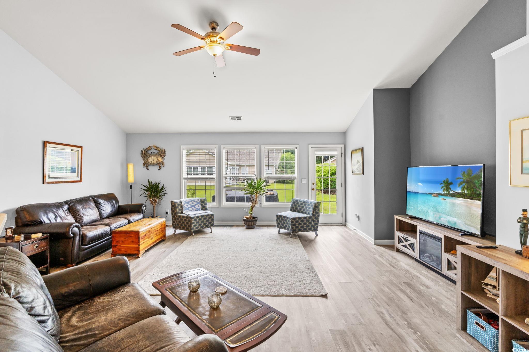 232 Marbella Drive Murrells Inlet, SC 29576 - Photo 6 of 40 Living room with lofted ceiling, wood finished flo
