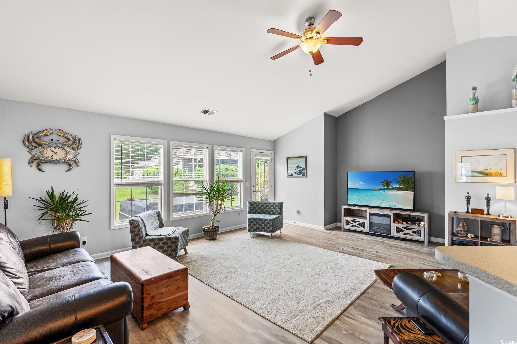 232 Marbella Drive Murrells Inlet, SC 29576 - Photo 7 of 40 Living room with vaulted ceiling, a ceiling fan, a