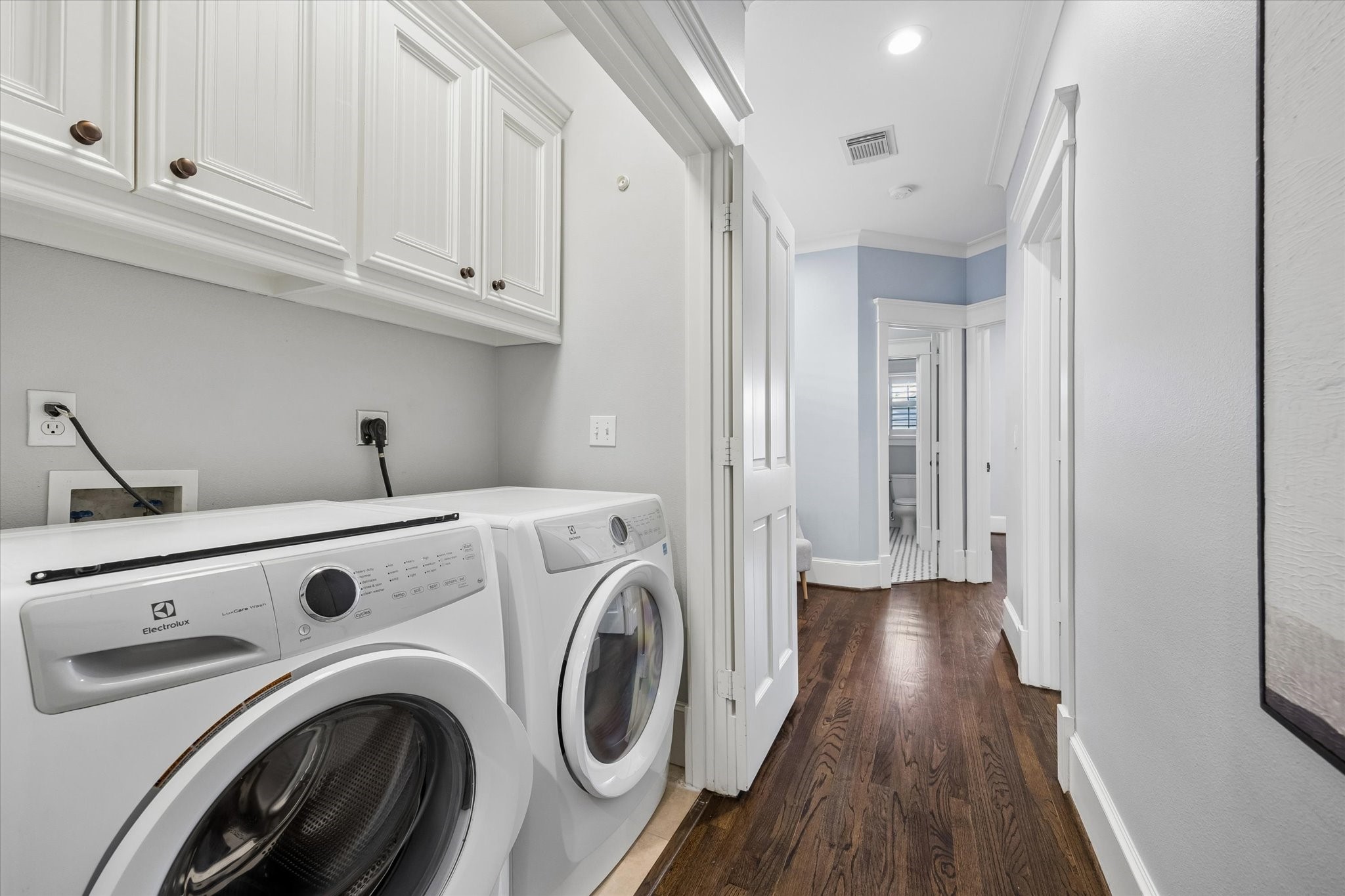 634 West 17th Street Houston, TX 77008 - Photo 26 of 42 The utility closet is tucked conveniently near the bedrooms upstairs, with built-in cabinetry above to keep laundry supplies and everyday essentials neatly within reach. (Please note, the washer and dryer are NOT included.)