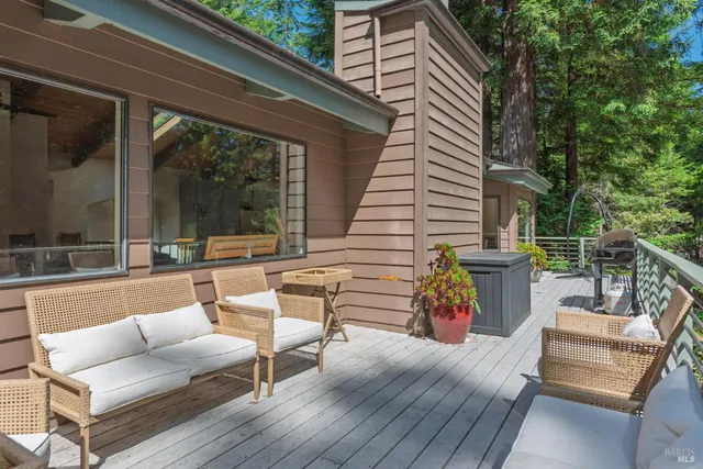 a view of a patio with couches and a table and chairs with wooden floor
