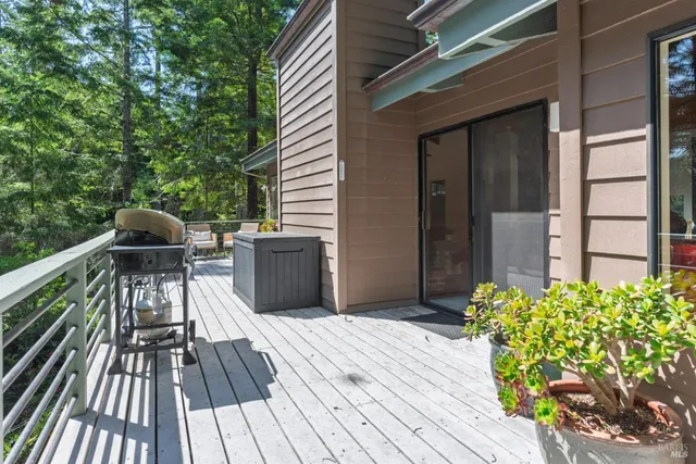 a view of balcony with wooden floor and seating space