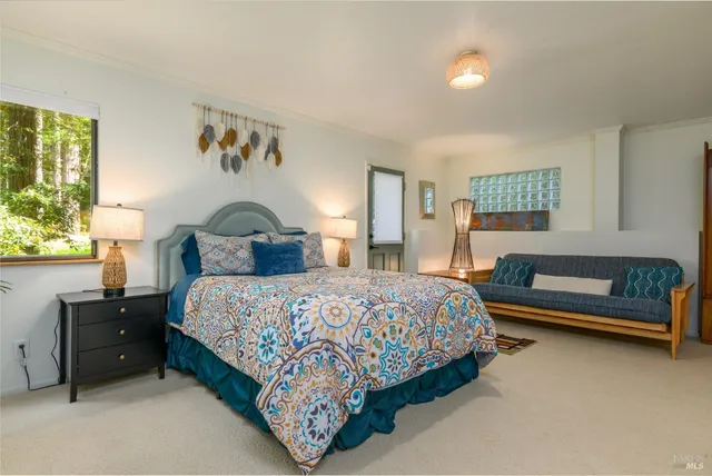 a bedroom with a bed and windows