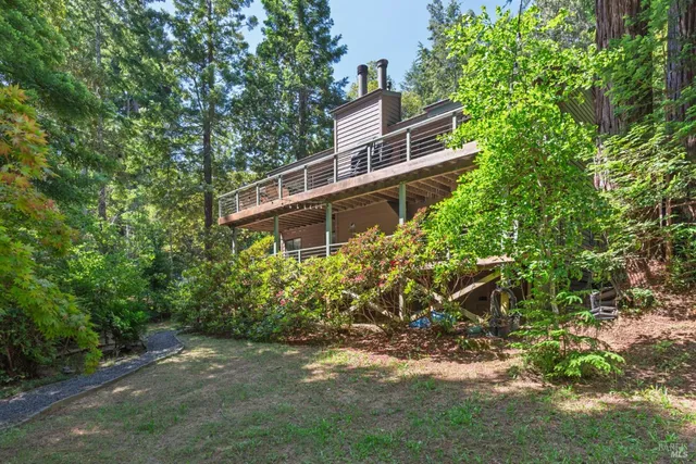 a view of a wooden house with a yard
