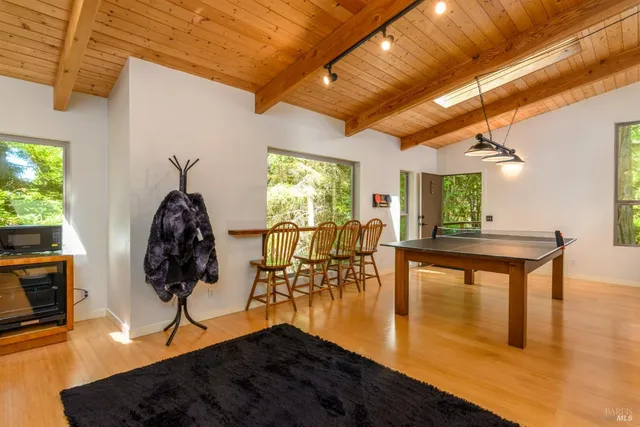 a view of a livingroom with furniture and a floor to ceiling window