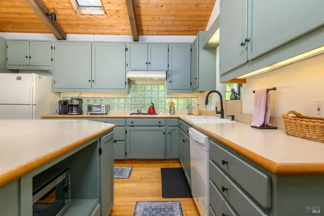 a kitchen with a sink a stove and cabinets