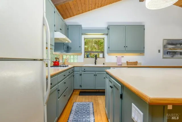 a kitchen with sink cabinets and window