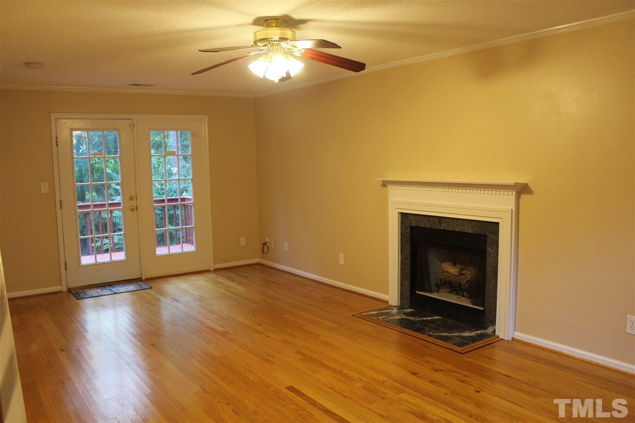 4613 Kresson Place Raleigh, NC 27616 - Photo 3 of 16 a view of an empty room with window and wooden floor
