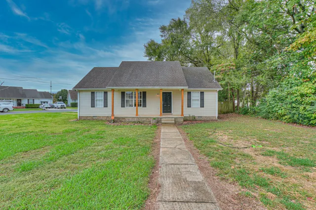 a front view of a house with a garden