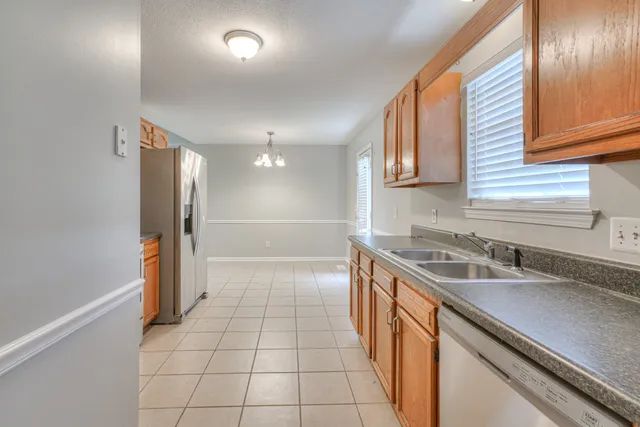 a kitchen with a sink and a refrigerator