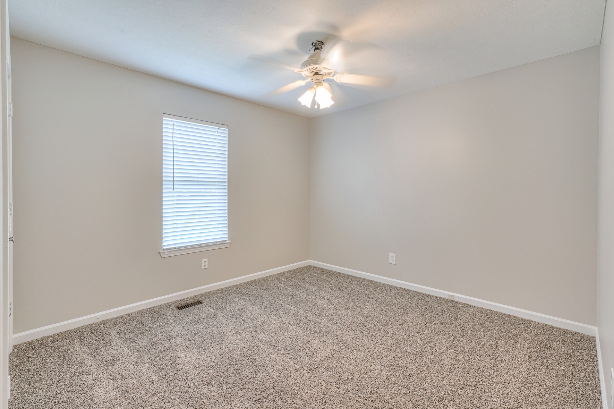 2426 Floyd Avenue Murfreesboro, TN 37127 - Photo 14 of 26 an empty room with windows and chandelier fan