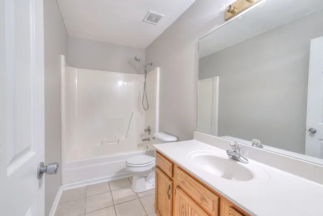 a bathroom with a sink toilet tub and shower